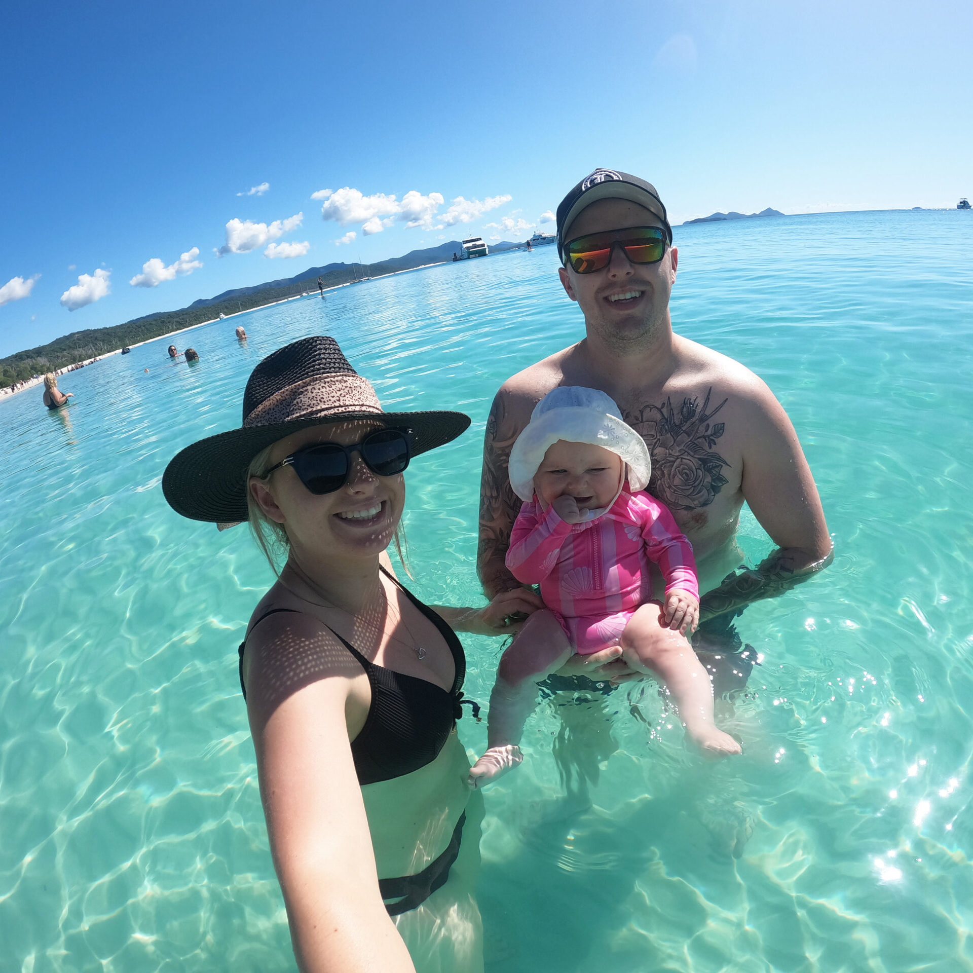 Jayden, Hailey, and I enjoying our first caravan trip to Queensland, sitting on the beach at the Whitsundays, embodying our family's passion for travel and adventure. Your Family-Friendly Guide
