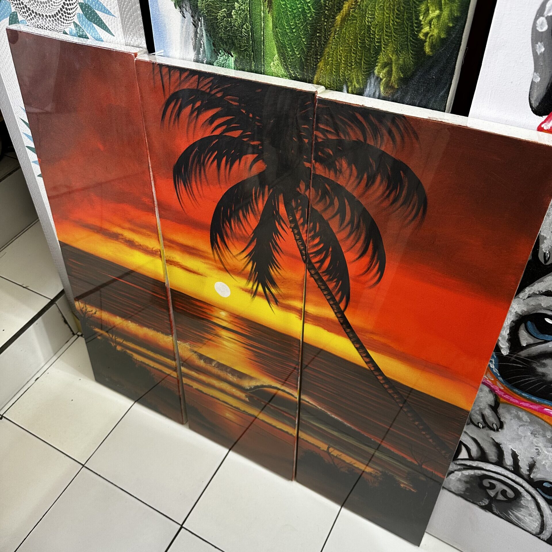 A stunning array of vibrant canvas paintings displayed in a Bali shop, showcasing the skilled artistry of local artisans.