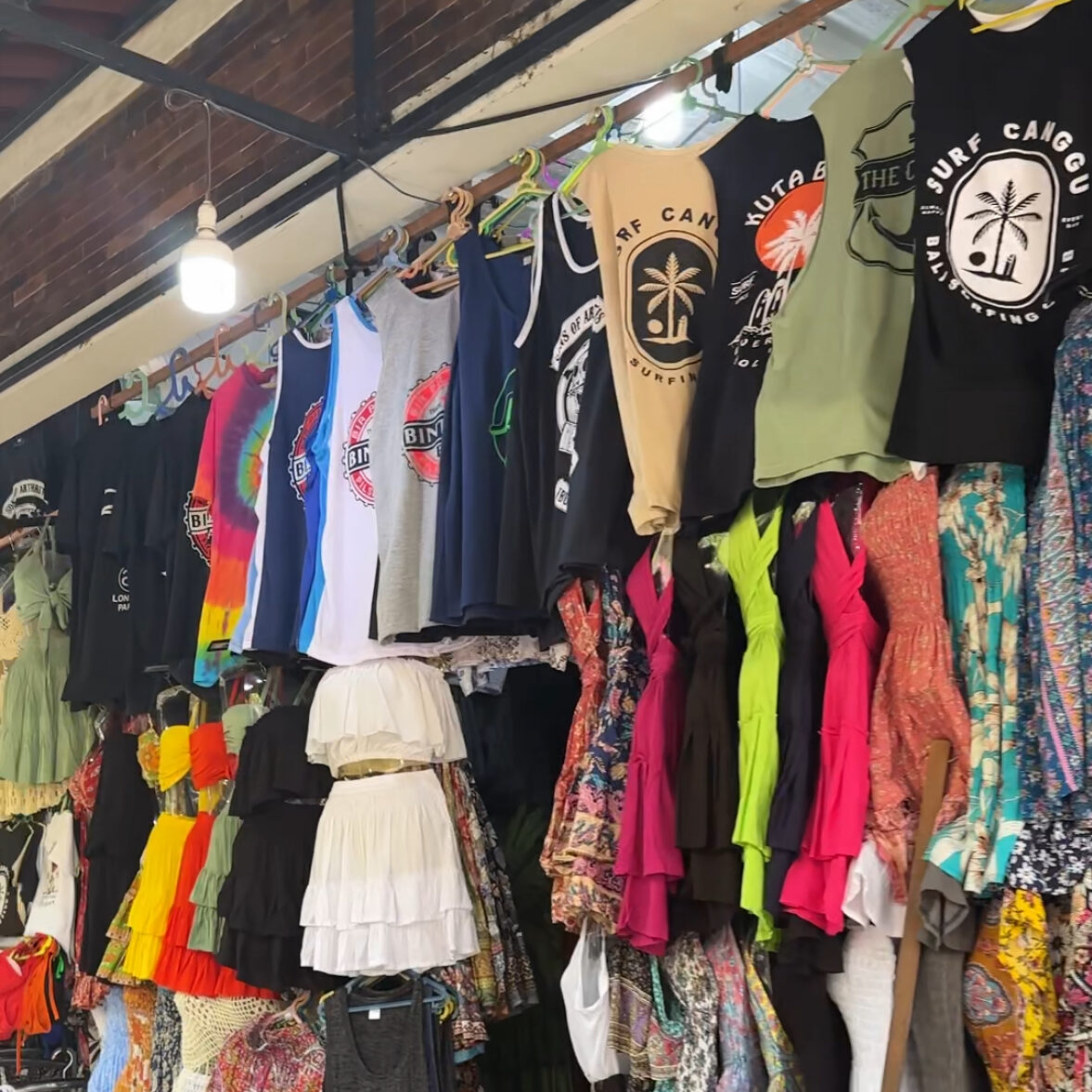 Colourful clothing displayed at a local market in Kuta, Bali, showcasing vibrant styles and unique shopping experiences.