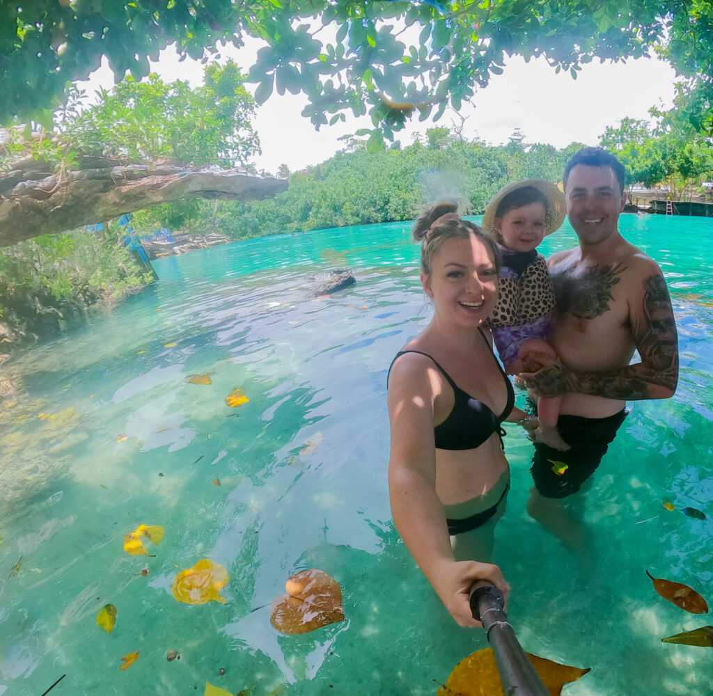 A joyful couple enjoying the vibrant blue waters of the lagoon, surrounded by lush greenery and tropical scenery.