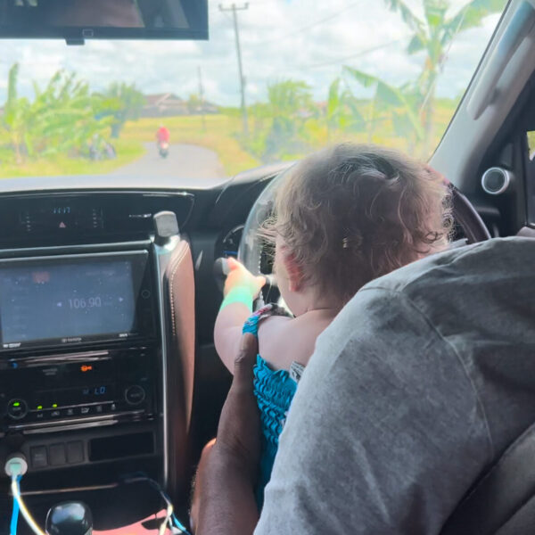 Hailey driving with a our Balinese family friend.